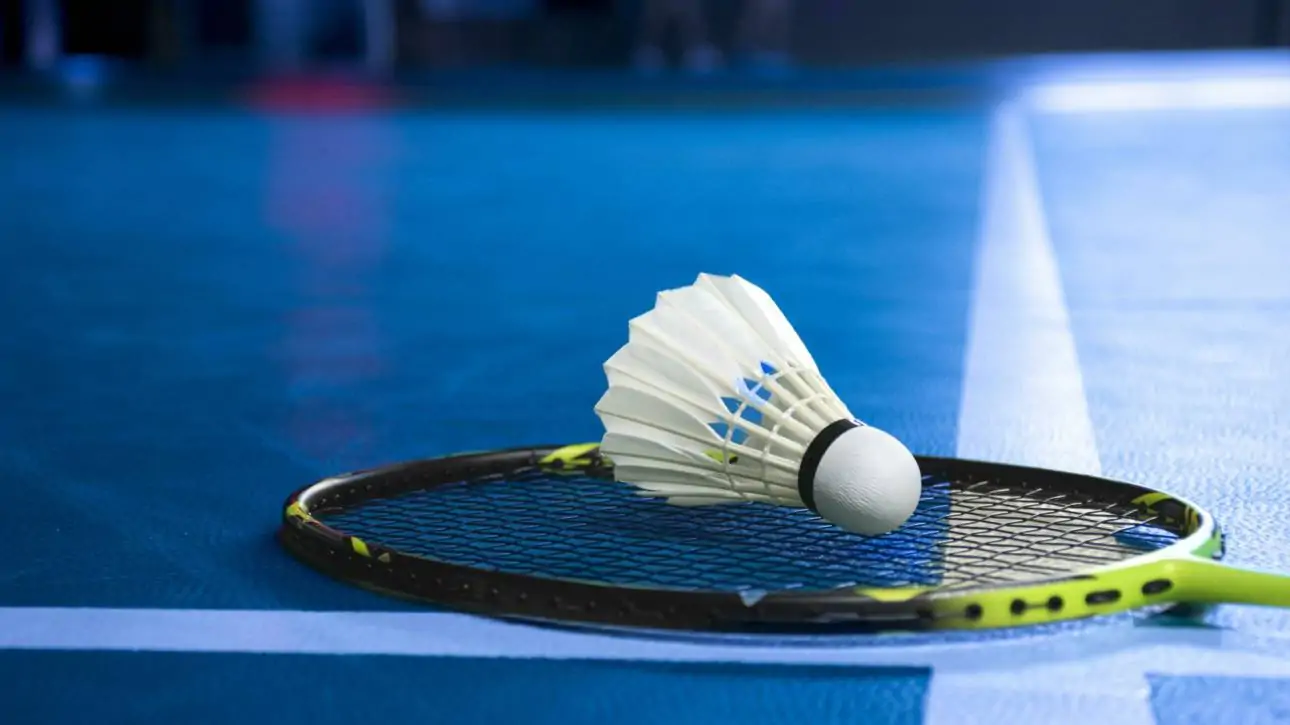 badminton-shuttlecock-and-racket-on-blue-floor-of-indoor-badminton-court