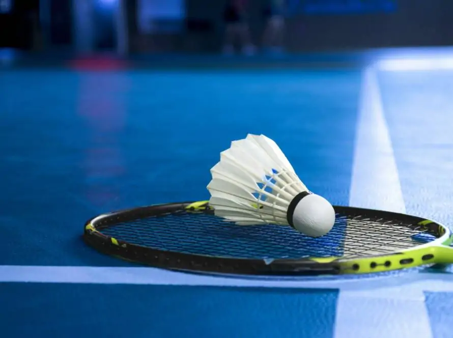 badminton-shuttlecock-and-racket-on-blue-floor-of-indoor-badminton-court